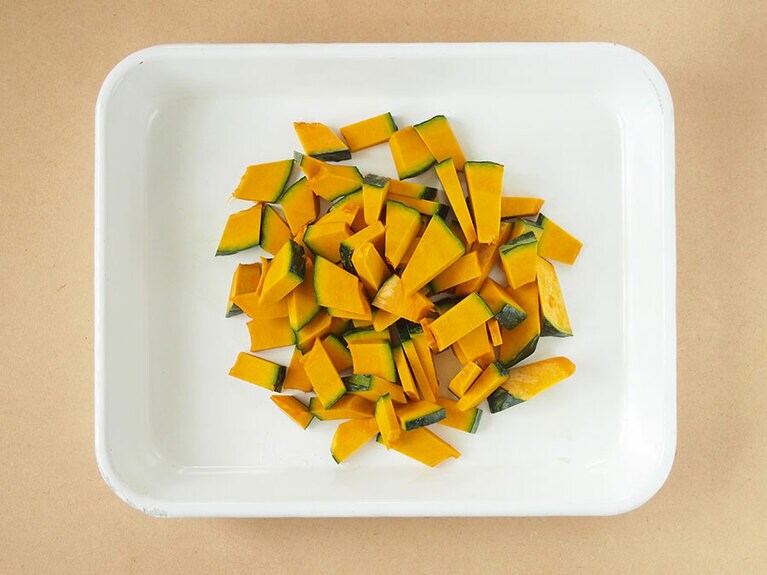 (1) かぼちゃは種をスプーンなどでくり抜き、食べやすい大きさに細かくカットします。