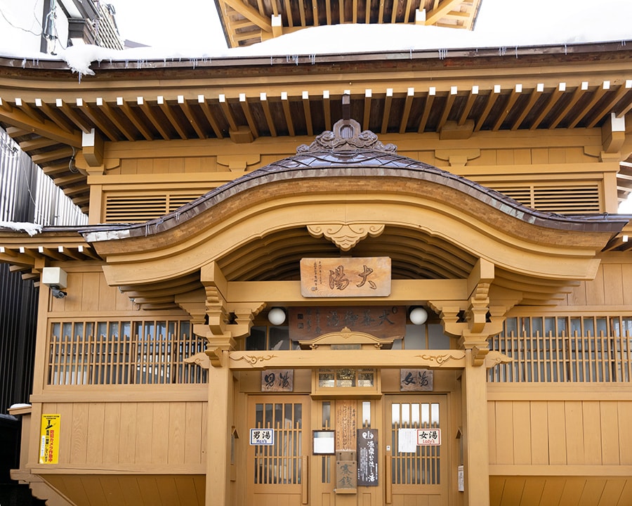 美しい木造りの建物が江戸時代の湯屋を思わせる「大湯」は野沢温泉のシンボル。