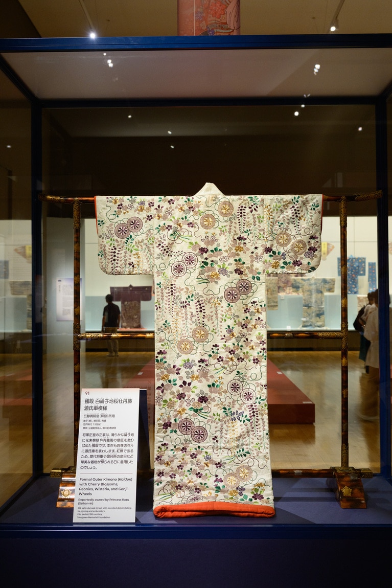 特別展「江戸☆大奥」会場写真。搔取 白綸子地桜牡丹藤源氏車模様 伝静寛院宮（和宮）所用 江戸時代 19 世紀 東京･公益財団法人 德川記念財団蔵 撮影：平松市聖　※現在は展示されていません