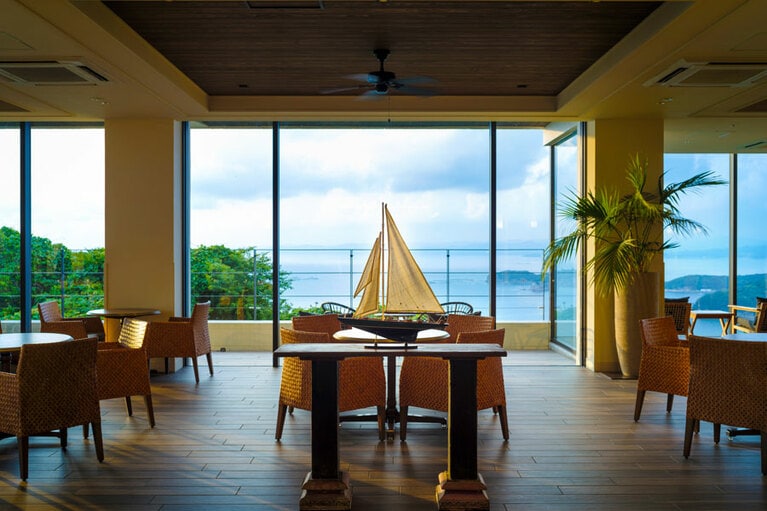 夕暮れの光に包まれるロビーラウンジ。大きな窓から眺める大海原は、刻々と表情を変えていきます。