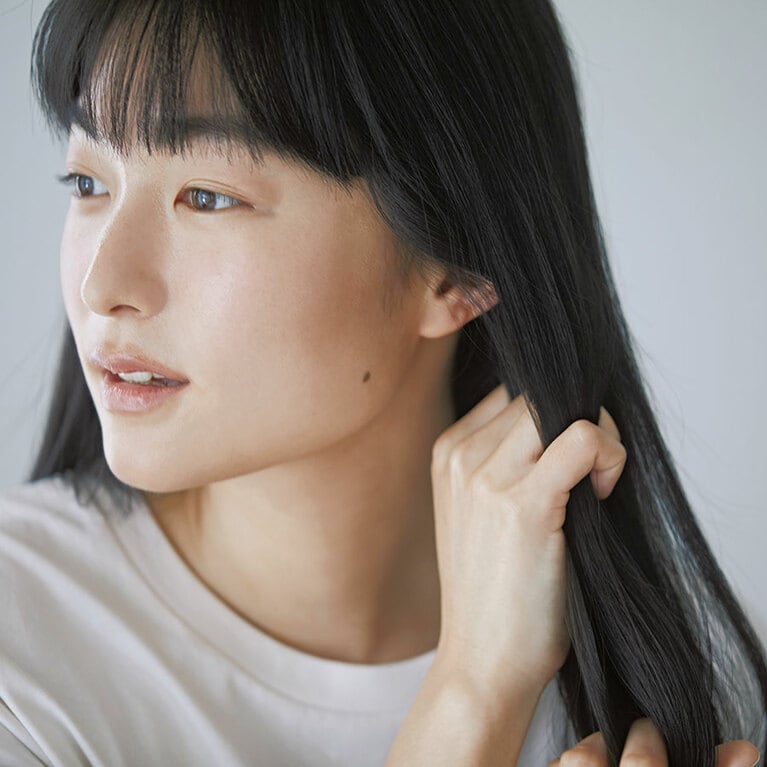 【オイル＆バームのダブル使いスタイリング STEP③】中間部分は手ぐしをするようにして、髪1本1本に薄くオイルをなじませツヤを出す