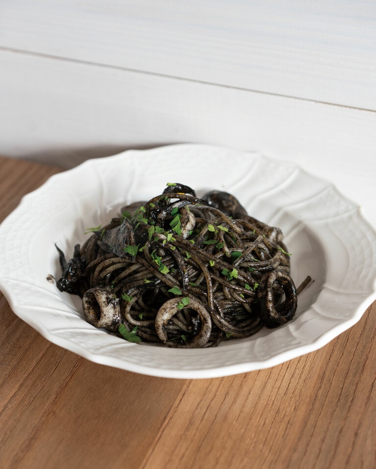 佐渡産ヤリイカを使用している「佐渡産ヤリイカのイカ墨パスタ」1,500円。ニンニクと唐辛子の効いたトマトソースにイカ墨のコクをプラス。