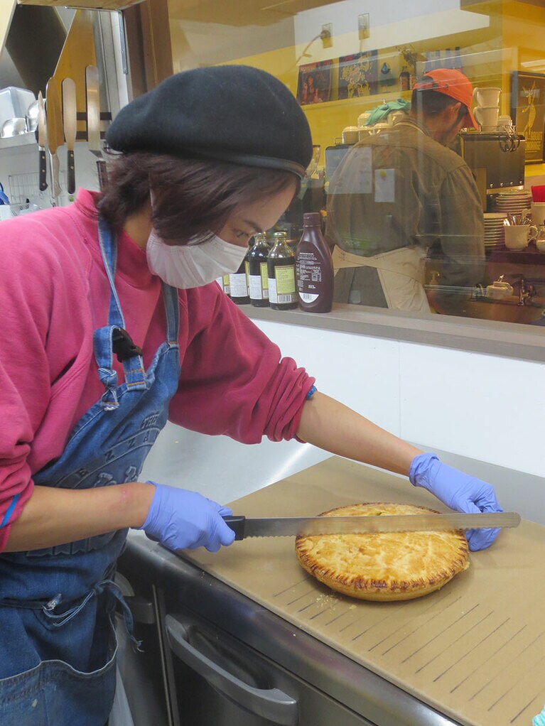 パイをカットする西田志保さん。