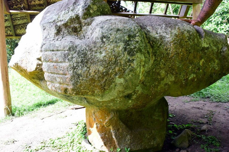 マルケサス諸島のイイポナの遺跡にある空飛ぶポーズのティキ。台座を見ると、ラマっぽい動物の絵が。