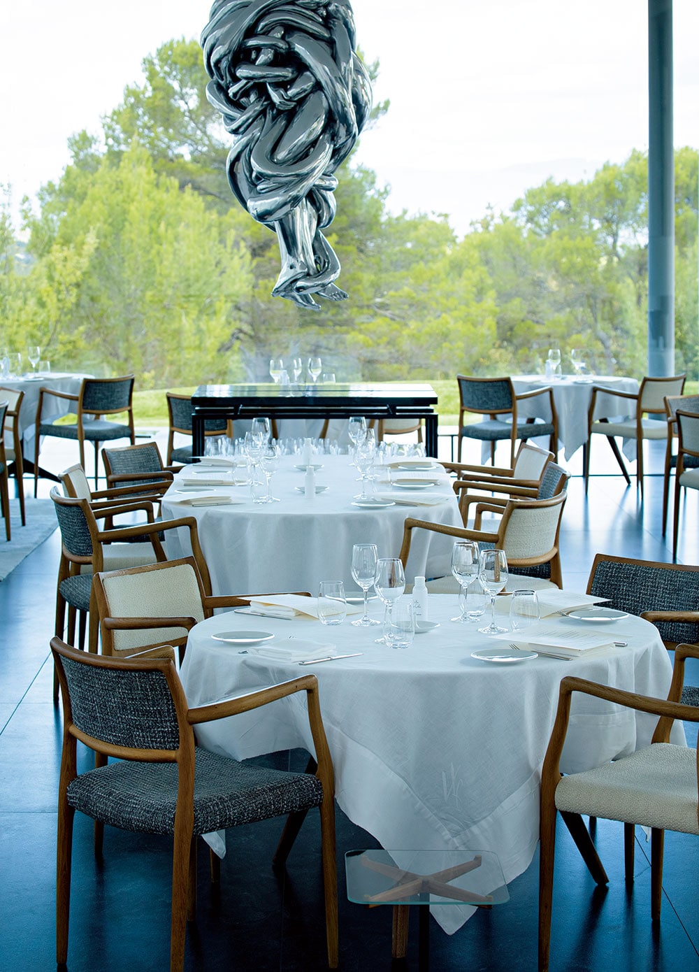 ルイーズ・ブルジョワの彫刻が中央に浮かぶホテルのレストランのメインダイニング。
