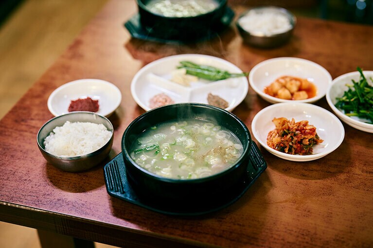 釜山といえばテジ（豚肉）クッパ。タクシードライバーが「釜山の人間はみんなここに行くんだよ」と教えてくれた海雲台にある「ウィリョン食堂」は、おいしいと聞きつけてやってくる若い客も多い。テジクッパ W6,000。臭みのまったくない、きれいな味のスープとご飯がサラサラ進む。サムジャンを混ぜて味変も。