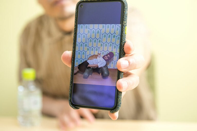 取材中も写真を見せてくれる川原さん「ほら、大久保はすぐに僕に乗りたがるんですよ」。