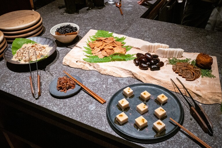 食後に登場したお茶請け。好きなものを自分で取るスタイル。「温泉水わらび餅」のような甘いものから「お漬物」のような辛いものまで幅広く用意されている。（撮影：石川博也）