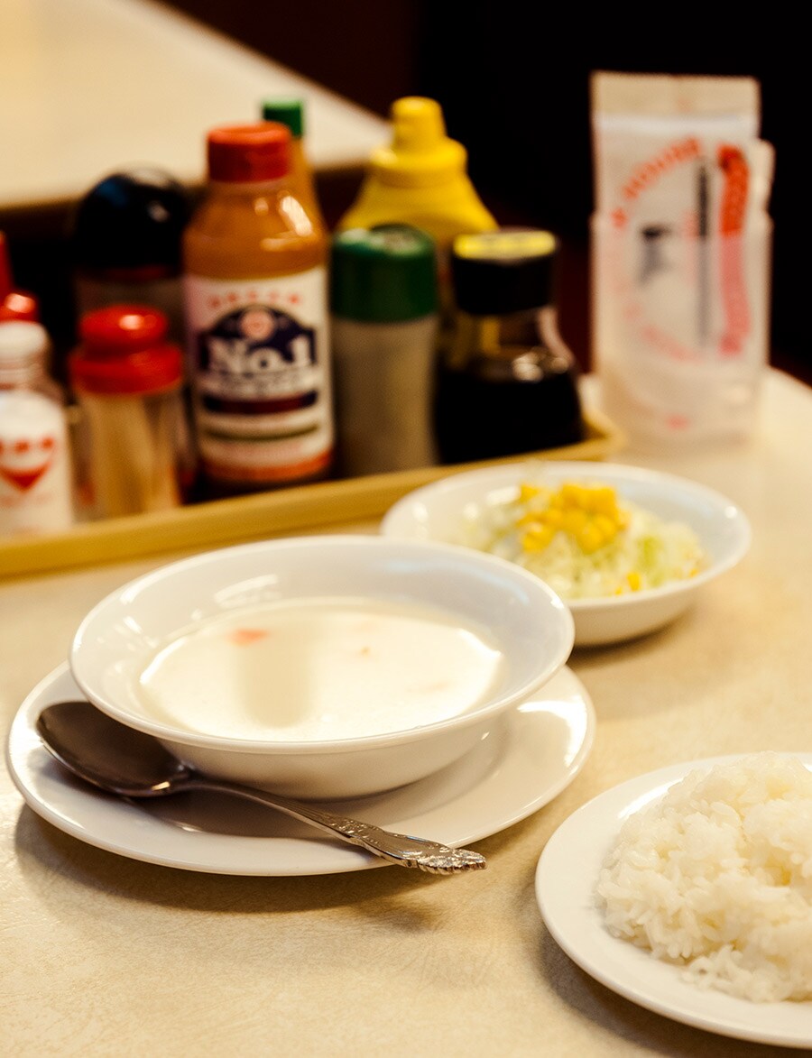左：セットのスープは豚骨ベース。
右：本土復帰前の沖縄で、米国の基準を満たした店に与えられた認定書、Aサインが今も残る。