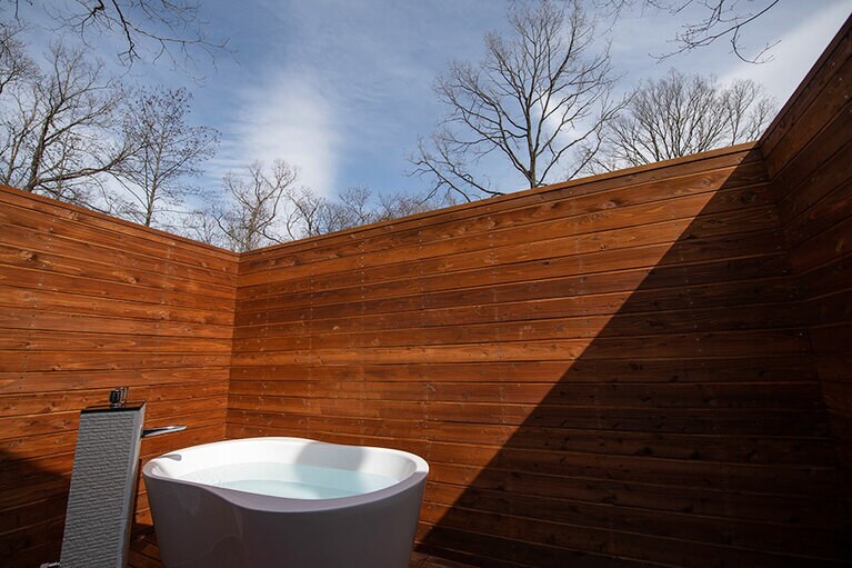 室内のシャワールームに続く屋外テラスにもバスタブが。周囲からは完全に囲われているため、安心して空の下のバスタイムを満喫できる。