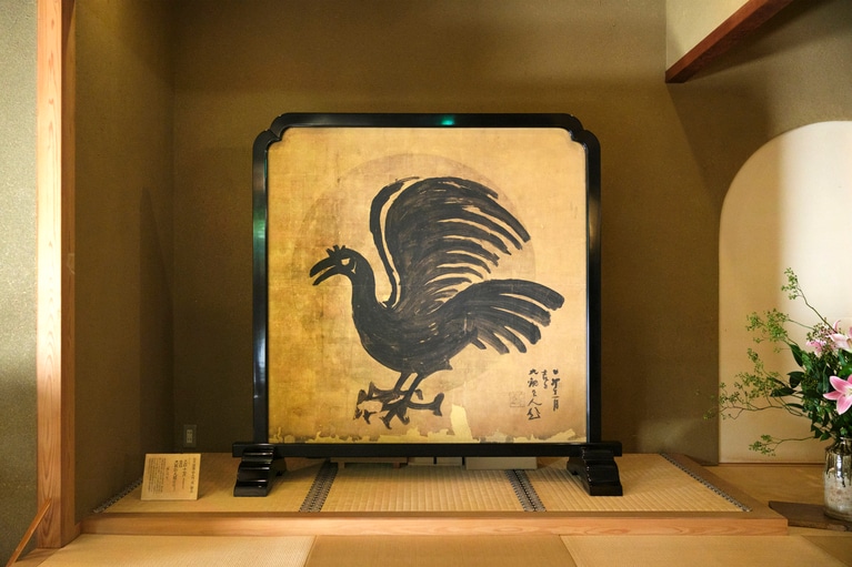 魯山人が描き上げた衝立「暁烏」。