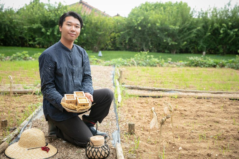 祭りに奉納される粟を育てている畑人の 伊藤 蓮さん。現在は「クモーマミ（小浜大豆）」などを栽培するほか、畑で育ったさまざまな「命草（ぬちぐさ）」はダイニングでも提供されます。