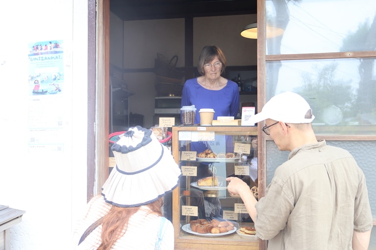 お客さんにお菓子を紹介するジュリーさんと朋さん。
