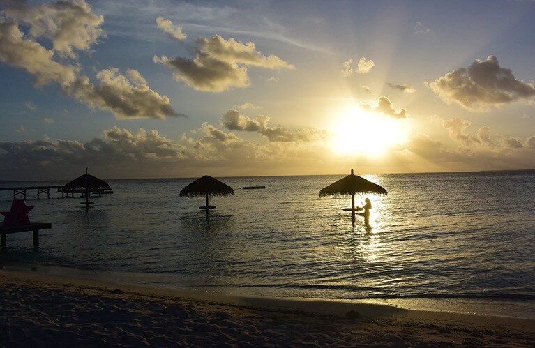 浅瀬のパラソルでロマンティックなサンセットを。