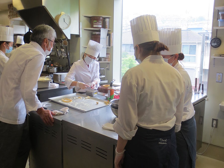 建物の2階の厨房では、中村さんの指導でたくさんのスタッフがお菓子を手作り。※左端が中村さん