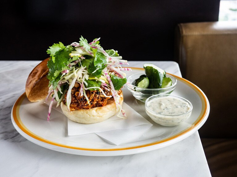 スパイシーフライドチキンバーガー、味噌ヨーグルトソース w/りんごとコールラビのサラダ2,100円。韓国のストリートフードにインスパイアされたスパイシーなバーガー。外はカリッと中はジューシーなチキンに、甘辛いコチュジャンソースは病み付きになる味わい。