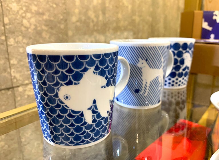 金魚や犬、猫が描かれたマグカップ。