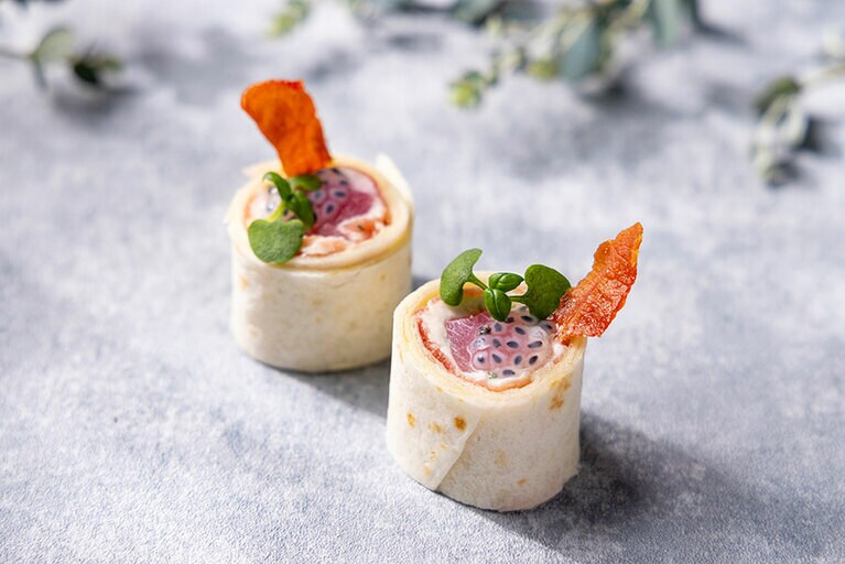 カプレーゼをイメージしたセイボリー「桃のカプレーゼロール」。桃のコンポート、リコッタクリームチーズ、生ハムをトルティーヤ生地で巻き、隠し味にバジルシードをプラス。