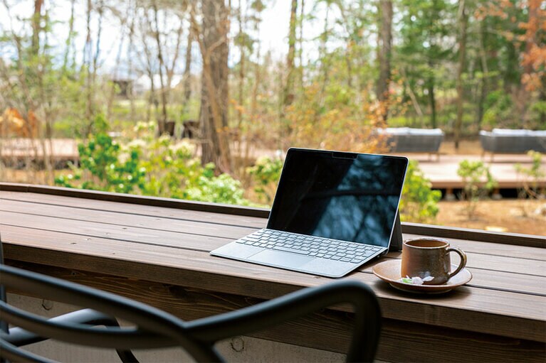 林の中に身を置ける陽だまりテラス。無料Wi-Fi完備だから、PCを持ち込んで仕事するのもOK。／休暇村 リトリート安曇野ホテル［長野・安曇野］