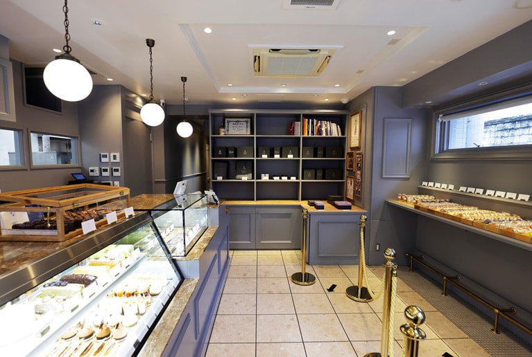 グレー基調の落ち着きある店内。生菓子のほか、ボンボン・ショコラや焼き菓子も。