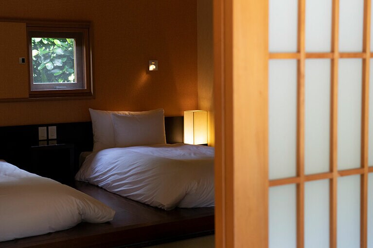 寝室はあえて天井を低めにした落ち着く空間。小窓に切り取られた緑は絵画に勝る美しさ。