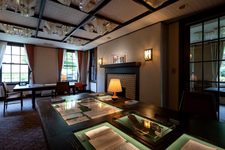 展示室全景。既設品を活かしつつ手を加えたテーブル、既設品と違和感なく仕立てられた新造テーブルに展示品が並べられる。