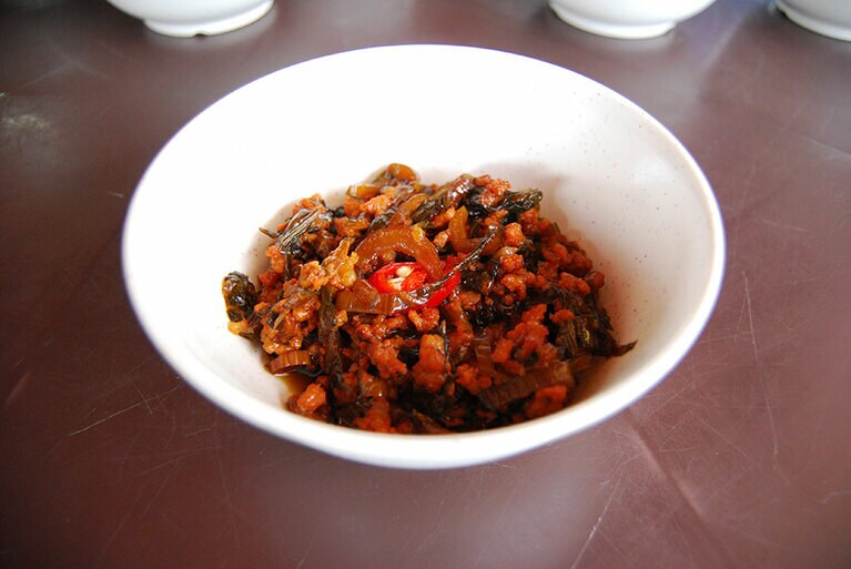 高菜似の漬物と豚ひき肉を醤油風のソースで炒めたもの。濃い味つけで、まさにご飯のおとも。