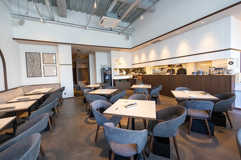 ガラス張りになった店内は、光が降り注ぎ、開放的な雰囲気。曲線を描いた壁のデザインは中東をイメージ。