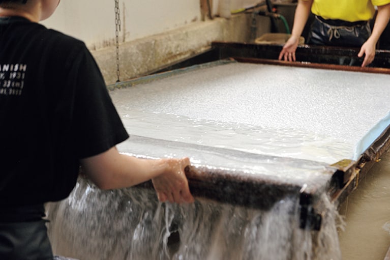 和紙の原料とトロロアオイの抽出液を合わせ、漉桁でくみ上げてはゆすり流して紙を漉く。