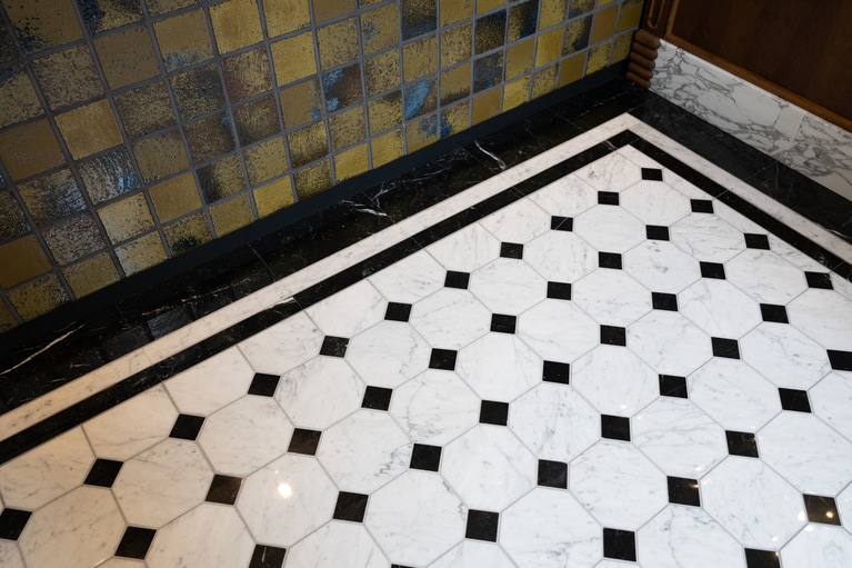 大階段のタイルを再現したカウンターとモノトーンの八角タイルの床。