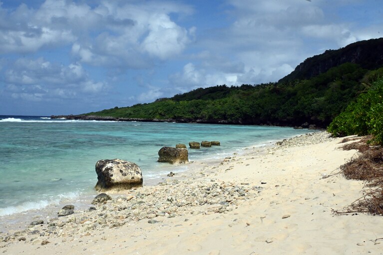 濃淡の青のコントラストが美しいウィングビーチ。背後には断崖が。