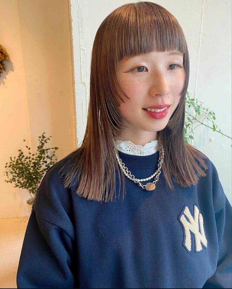 顔まわりのデザインが印象的なストレートミディ。