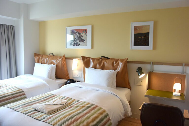 機能性を重視したゲストルーム。広くはないけれど、効率的に収納されています。