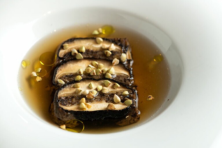スペシャリテの原木椎茸のテリーヌ“原点”は、カツオや鶏などの出汁で作ったソースで登場。「シャトー・メルシャン リヴァリス」“北信左岸シャルドネ2019”と合わせて。