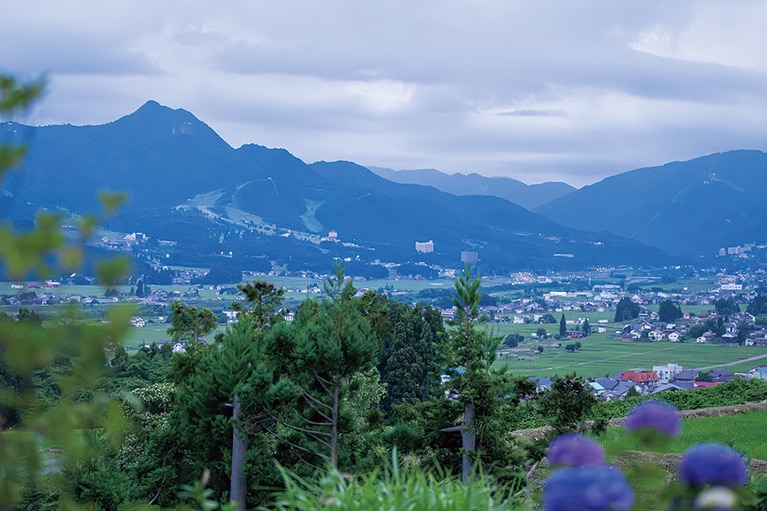 棚田が連なる田園集落の丘に建ち、正面に日本百名山の巻機山を望む。秋から春の晴れた日の朝は雲海が現れることも。（里山十帖 THE HOUSE IZUMI　新潟）