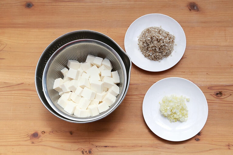 麻婆豆腐を作る。ネギ、きのこは粗みじん切り、絹ごし豆腐は茹でて賽の目に切っておく。