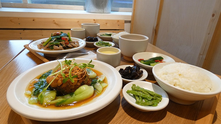 定食は8種類で、280元～350元。季節によってメニューは変わります。写真手前は高菜と蓮の実が入ったひき肉料理。奥は客家料理の酸菜(からし菜の漬物)と豚肉を炒めたもの。そのほか、おやつには黒糖カステラが人気です。