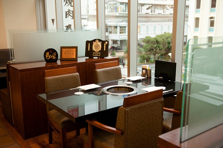 ［焼肉 もとぶ牧場　那覇店］席もゆったり配置され、半個室など、パーテーションを活用した店内。