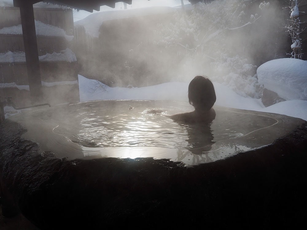 客室「KURA02」の露天風呂。外気は寒くても湯温が落ちないのは、蔵王石の保温力の賜物。