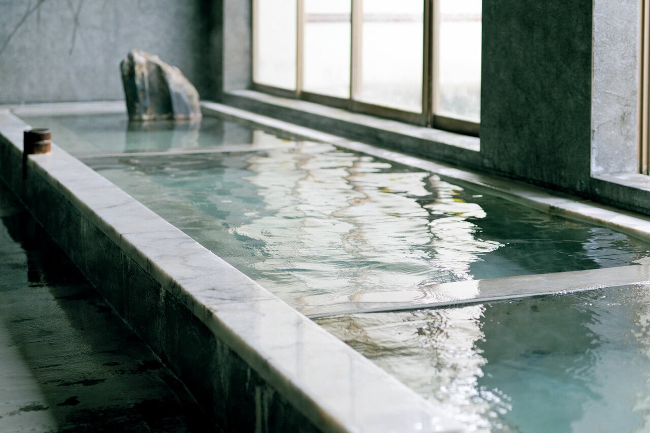 ぬる湯の浴槽に長湯することで副交感神経がリラックス。3つの温度帯の湯船に美肌の湯がかけ流しになっている。