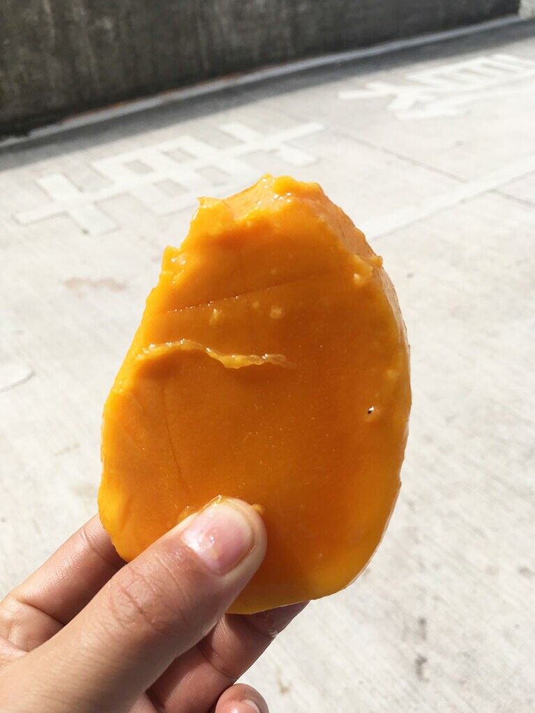 左の写真のマンゴーの中身。種の周りにも実がいっぱい。直接かぶりつくのがオススメ。