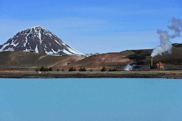 渋めな色彩の風景の中、鮮やかなブルーの湖が視界に飛び込むとハッとさせられる。煙をたちのぼらせているのは、地熱発電所。