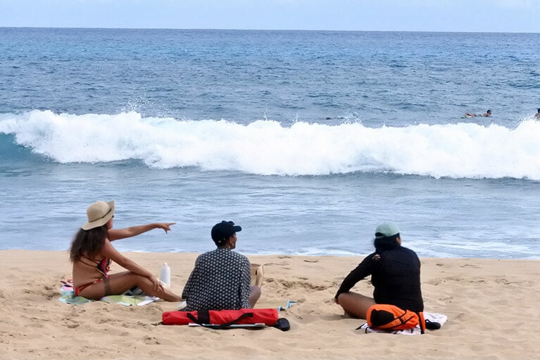 仲間か、ファミリーなのか、サーファーに向かって声援を送る人々。