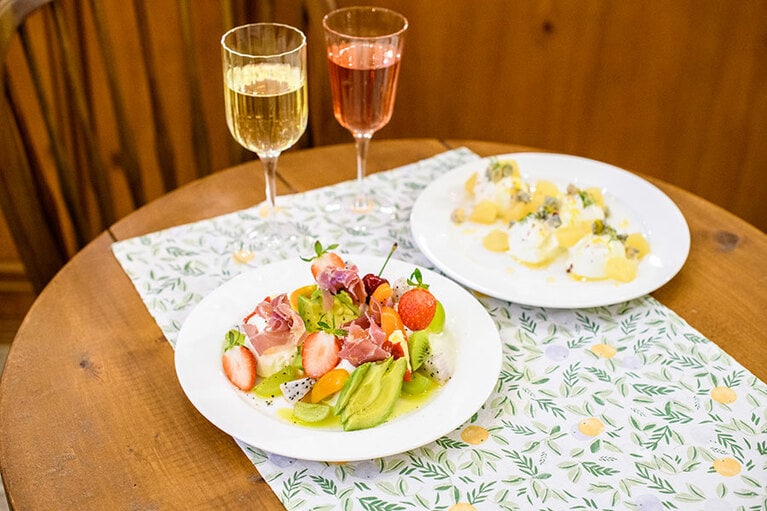 ギリシャヨーグルトが主役のプレート。生ハムとアボカド、トリュフオイル(左) W19,000、ゴルゴンゾーラと桃(右) W16,000。フルーティーなギリシャワインとペアリングで。白、ロゼのグラス 各W10,000。