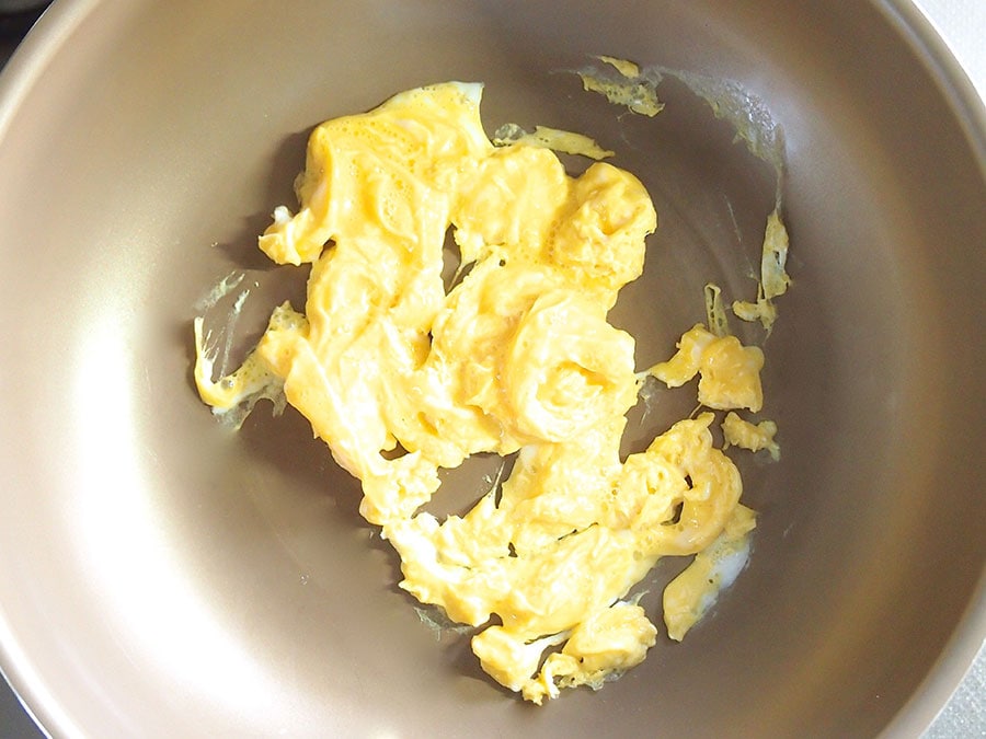 (2) フライパンを温め、ごま油を敷いたら溶いた卵を入れ、簡単に混ぜて8割ほど火を通します。一旦バットなどに取り出します。