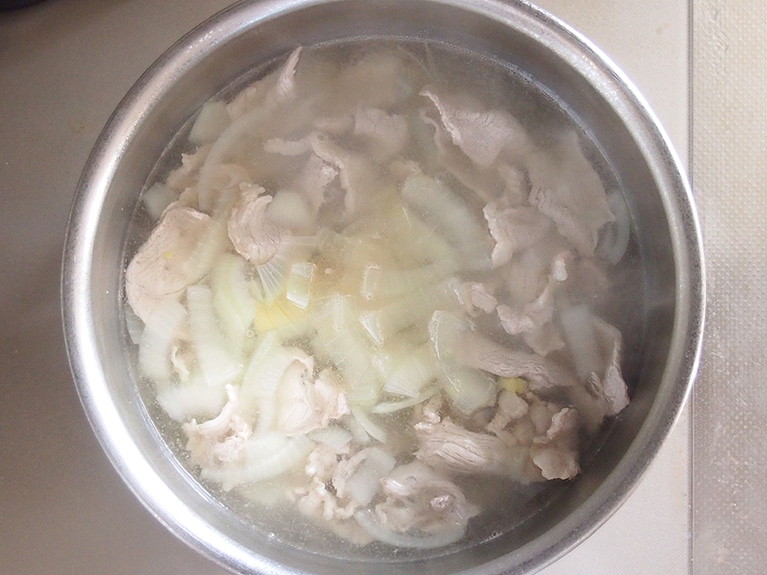 アクをすくいながら中火で加熱。アクが出てこなくなったら、玉ねぎを入れる。