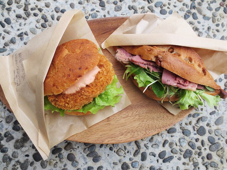 きまぐれサンド「米粉クルミ(オレンジ風味) パン×ビーフパストラミ」380円、「米粉ゴマチーズパン×コロッケ・オーロラソース」380円。