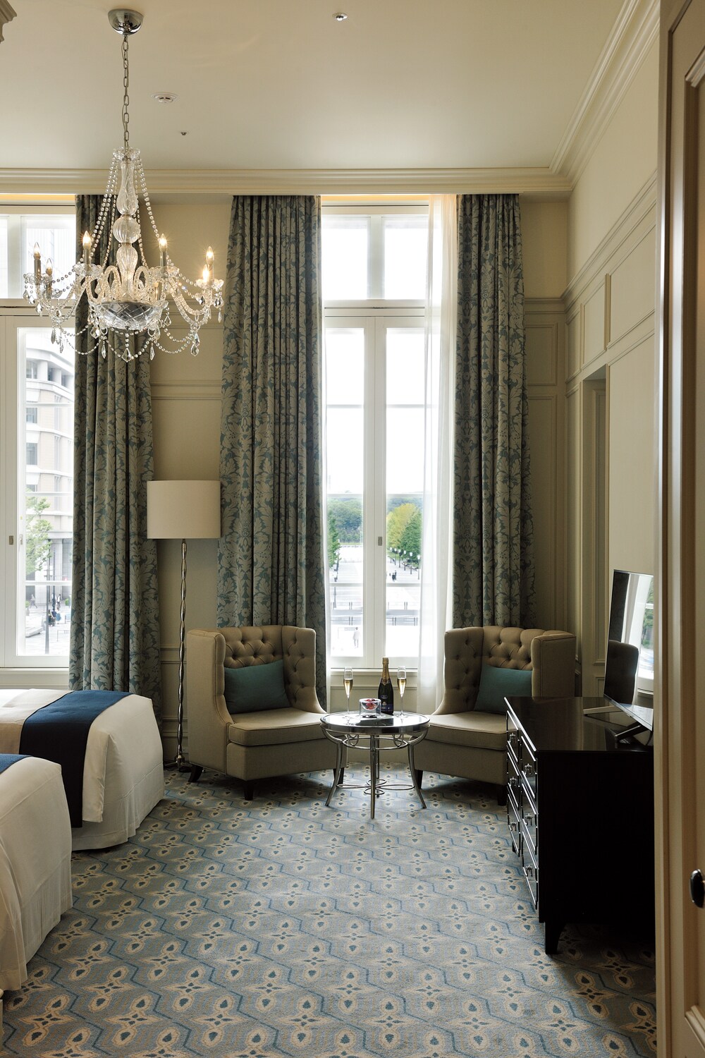 クラシカルな大きな窓の向こうに皇居外苑の緑を眺められる客室“パレスビュープレミアムデラックスツイン”。