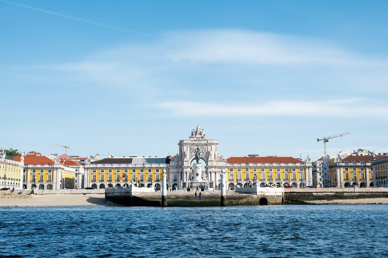 【コメルシオ広場】1755年の震災後、ポンバル侯爵による都市再建の中心となった大広場。政府機関も数多く擁する、テージョ川へ開かれた現在のリスボンを象徴する空間。外国の賓客を乗せた船は広場中央にある2本の大理石の柱を目印に着岸していた。