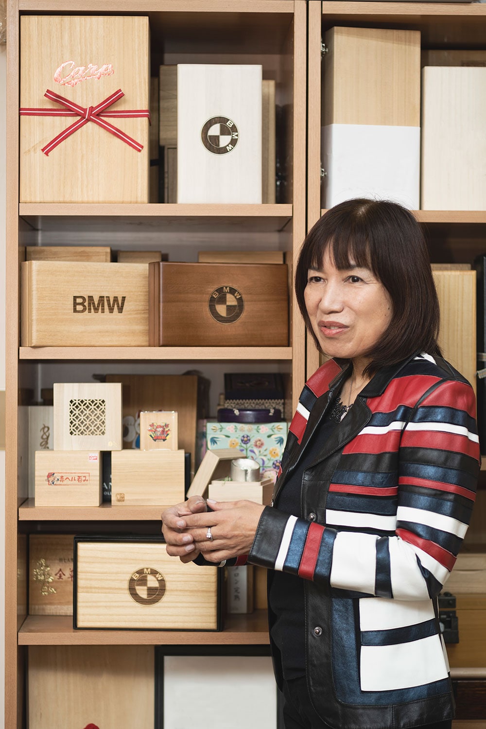 代表の桑田真由美さん。写真のBMW7シリーズの桐箱は納車の際のキーの格納箱。